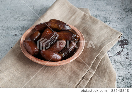 Algerian dates deglet nour on a light background in a bowl 88548848