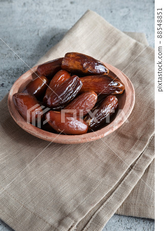 Algerian dates deglet nour on a light background in a bowl 88548851