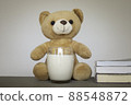 Brown teddy bears and a glass of fresh milk with books. Education and health concept. 88548872