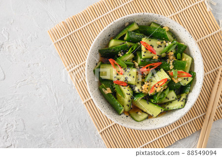 Asian spicy salad Broken Cucumbers with fresh coriander, ginger, pepper chili, black vinegar. 88549094
