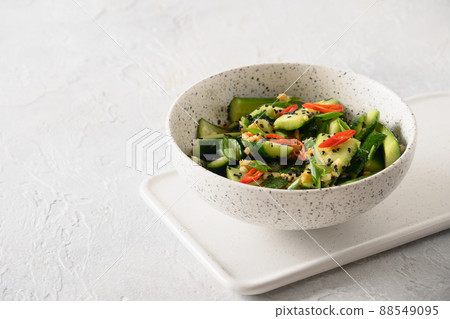 Asian spicy cold appetizer Broken Cucumbers with fresh coriander, ginger, pepper chili, black vinegar. 88549095