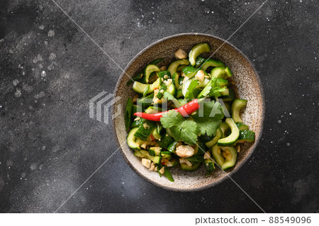 Asian spicy broken Cucumber salad with fresh coriander, ginger, pepper chili, black vinegar. 88549096