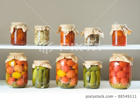Homemade marinated tomatoes. Canned vegetables in glass jar. Homemade marinated tomatoes. Canned vegetables in glass jar. 88549111