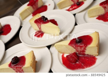 High Angle Full Frame Image of Plates of Cheesecake with Strawberry, Cherry and Blackberry Compote 88549425