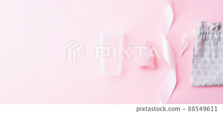 Menstrual cramp, use menstrual cup inside vagina. Pink ribbon with menstrual cup. Menstruation feminine period. Medical healthcare gynecological banner. Menstrual cramp, use menstrual cup inside vagina. Pink ribbon with menstrual cup. Menstruation feminine period. Medical healthcare gynecological banner. 88549611