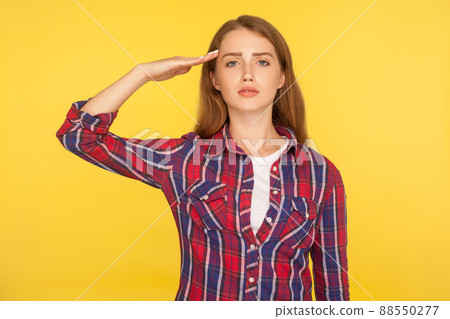 Yes, sir. Portrait of serious young ginger woman in checkered shirt saluting with respect and responsibility, patriotic citizen listening order with honor. studio shot isolated on yellow background Yes, sir. Portrait of serious young ginger woman in checkered shirt saluting with respect and responsibility, patriotic citizen listening order with honor. studio shot isolated on yellow background 88550277