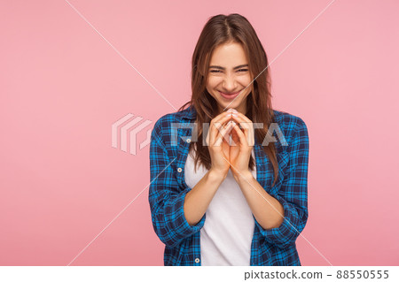 Portrait of sneaky scheming young woman in checkered shirt thinking devious plan with cunning evil face expression, having slyly idea to prank friend. indoor studio shot isolated on pink background Portrait of sneaky scheming young woman in checkered shirt thinking devious plan with cunning evil face expression, having slyly idea to prank friend. indoor studio shot isolated on pink background 88550555