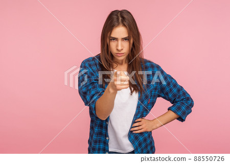 I am warning you. Portrait of displeased angry girl in checkered shirt showing admonishing finger gesture, scolding and giving advice to avoid danger. indoor studio shot isolated on pink background 88550726