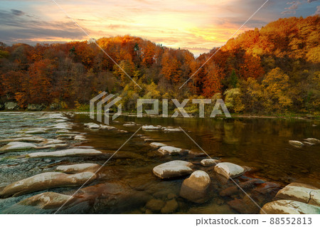 View of the waterfall in autumn. Waterfall in autumn colors. Mountain river in the autumn landscape. Ukraine, river Stryj. 88552813