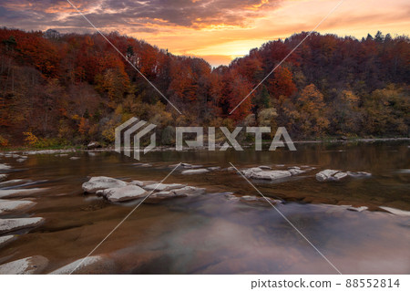 View of the waterfall in autumn. Waterfall in autumn colors. Mountain river in the autumn landscape. Ukraine, river Stryj. 88552814