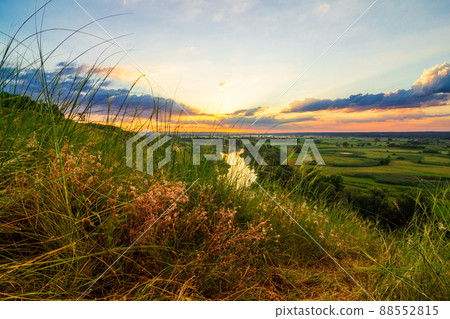 A beautiful valley with a river, blue sky with large clouds and bright sun. Aerial 88552815