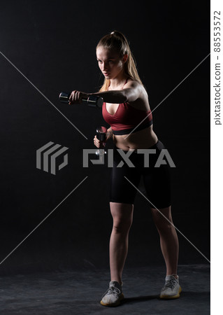 Beautiful girl with on black background a A dumbbells stands Keira Knightley girl dumbbells sports caucasian, from female woman from person for bodybuilding dumbbell, sportswear wellness. Sweat Beautiful girl with on black background a A dumbbells stands Keira Knightley girl dumbbells sports caucasian, from female woman from person for bodybuilding dumbbell, sportswear wellness. Sweat 88553572