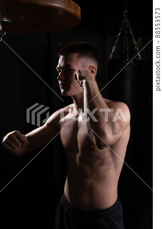 Athlete bag blows The the practices boxer glove black young background competition, from strong muscle from sport from exercise lifestyle, studio sweat. Backlit model box, sexy Athlete bag blows The the practices boxer glove black young background competition, from strong muscle from sport from exercise lifestyle, studio sweat. Backlit model box, sexy 88553573