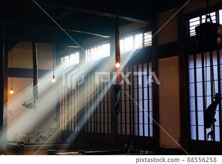 Light shining through a small window in an old folk house 88556258