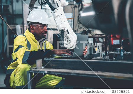 Factory worker working with laptop computer to do adept procedure checklist Factory worker working with laptop computer to do adept procedure checklist 88556891