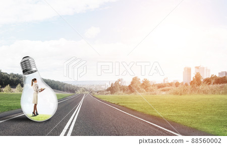 Businesswoman inside light bulb Businesswoman inside light bulb 88560002