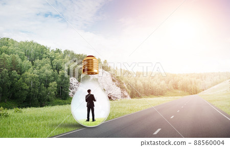 Businessman inside light bulb Businessman inside light bulb 88560004