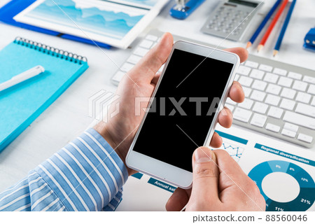 businessman with a smartphone, works in the office businessman with a smartphone, works in the office 88560046