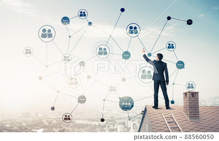 Businessman on house roof presenting networking and connection c 88560050