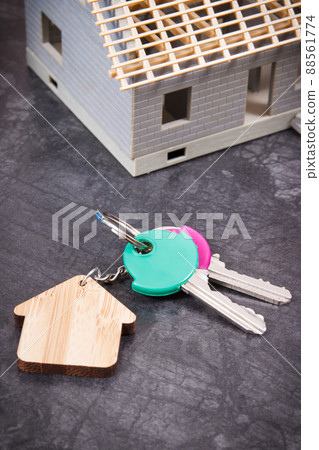 Small house under construction and keys. Building home concept Small house under construction and keys. Building home concept 88561774