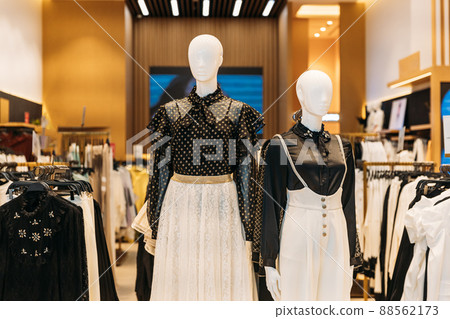 Female mannequin in store mall market. Fashion clothes - blouse, skirt. Mannequins dressed in female woman fashion clothes in store of shopping center. Clothes on hangers in store of shopping center Female mannequin in store mall market. Fashion clothes - blouse, skirt. Mannequins dressed in female woman fashion clothes in store of shopping center. Clothes on hangers in store of shopping center 88562173