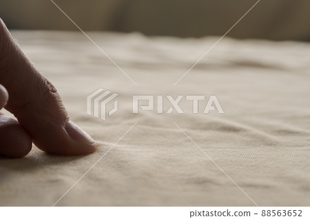 man hand touching yellow cotton fabric man hand touching yellow cotton fabric 88563652