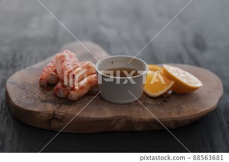 Crab served with sauce and sweet lemon on olive wood board 88563681
