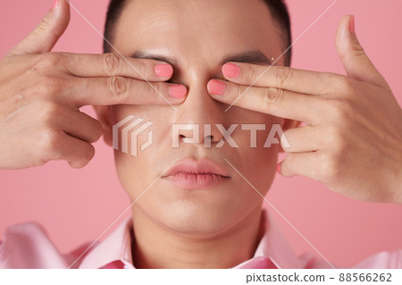 Young Man Covering Eyes 88566262