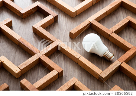 Light bulb in the maze game built by wood blocks, finding the right way to the success, idea concept Light bulb in the maze game built by wood blocks, finding the right way to the success, idea concept 88566592