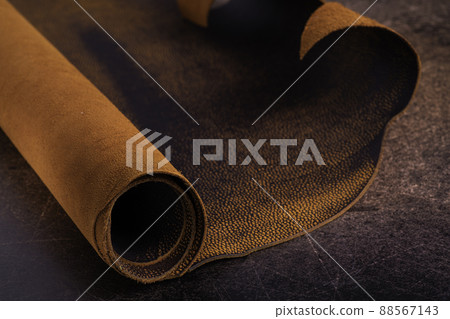 Roll of natural brown leather. Material for manufacture of bags, shoes, clothing and accessories. 88567143
