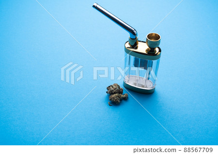 Hookah with marijuana on a blue background close-up. 88567709