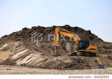 Image of a mountain of earth and sand and a shovel car 88568985
