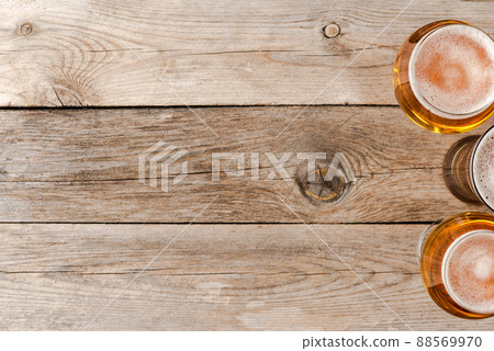 Overhead shot of beer glasses on wooden table. 88569970