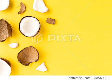 Coconut pieces on yellow background with copyspace. Flat lat. Top view Coconut pieces on yellow background with copyspace. Flat lat. Top view 88569998