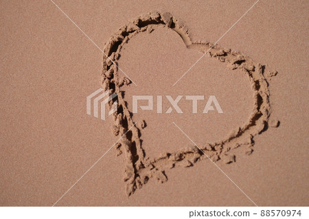 Heart is painted on sand of sea beach closeup 88570974