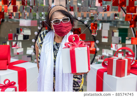 Attractive Senior Woman with Gift in Hand. Attractive Senior Woman with Gift in Hand. 88574745
