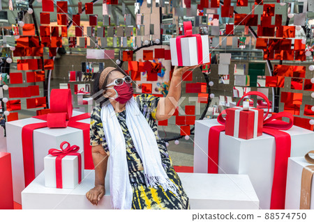 Attractive Senior Woman with Gift in Hand. 88574750