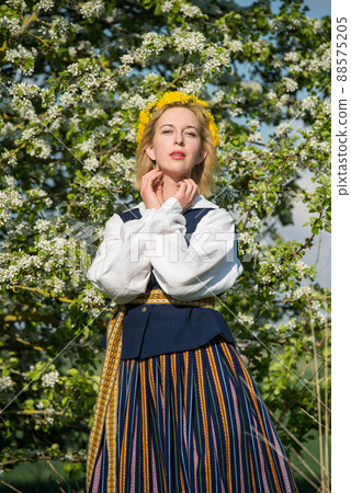 Beautiful feminime woman in national dress with white spring flowers 88575205