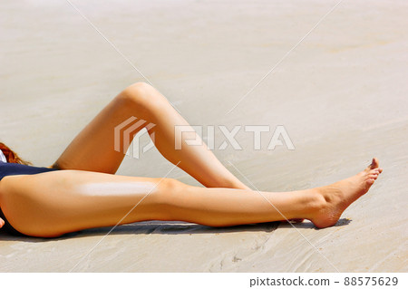 Woman apply sun protection cream on her smooth tanned legs Woman apply sun protection cream on her smooth tanned legs 88575629
