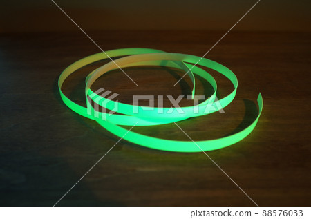 A thin phosphorescent tape that glows green 88576033