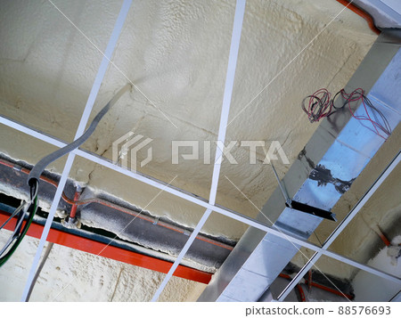 SELANGOR, MALAYSIA - MARCH 10, 2022: Polyurethane insulating foam that has been sprayed and covered the surface below the concrete slabs. Serves as a layer of thermal insulation for the building. SELANGOR, MALAYSIA - MARCH 10, 2022: Polyurethane insulating foam that has been sprayed and covered the surface below the concrete slabs. Serves as a layer of thermal insulation for the building. 88576693