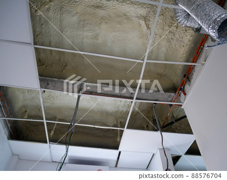 SELANGOR, MALAYSIA - MARCH 10, 2022: Polyurethane insulating foam that has been sprayed and covered the surface below the concrete slabs. Serves as a layer of thermal insulation for the building. SELANGOR, MALAYSIA - MARCH 10, 2022: Polyurethane insulating foam that has been sprayed and covered the surface below the concrete slabs. Serves as a layer of thermal insulation for the building. 88576704