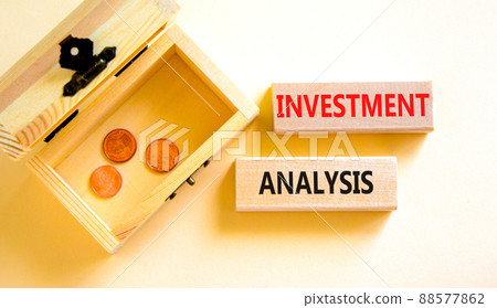 Investment analysis symbol. Wooden blocks with concept words Investment analysis on beautiful white background. Wooden chest with coins. Business investment analysis concept. Copy space. 88577862