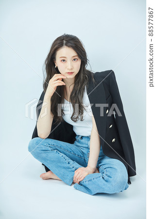 Fashion young woman in a shoulder jacket 88577867