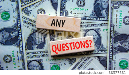 Any questions symbol. Concept words Any questions on wooden blocks on a beautiful background from dollar bills. Business and Any questions Q and A concept, copy space. 88577881