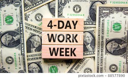 4-day work week symbol. Concept words 4-day work week on wooden blocks on beautiful background from dollar bills. Copy space. Business and 4-day work week and short workweek concept. 88577890