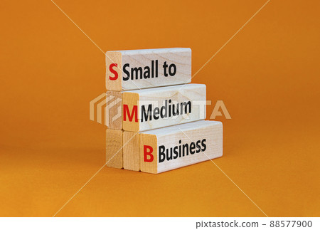 SMB small to medium business symbol. Words SMB small to medium business on blocks on a beautiful orange background. Business and SMB small to medium business concept. Copy space. 88577900