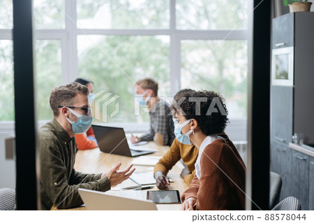 employees in protective masks work in the hall of the coworking employees in protective masks work in the hall of the coworking 88578044