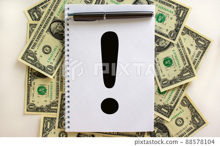 White note with exclamation point on beautiful background from dollar bills. Metalic pen. Concept. Copy space. White note with exclamation point on beautiful background from dollar bills. Metalic pen. Concept. Copy space. 88578104