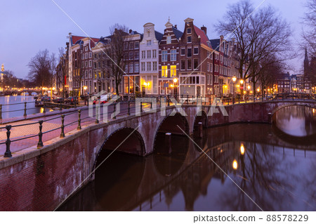 Beautiful old houses on the city waterfront of Amsterdam at sunset. Beautiful old houses on the city waterfront of Amsterdam at sunset. 88578229